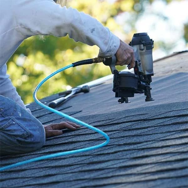 man doing the roofing with machine