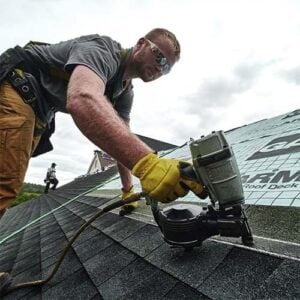 employee repairing roof
